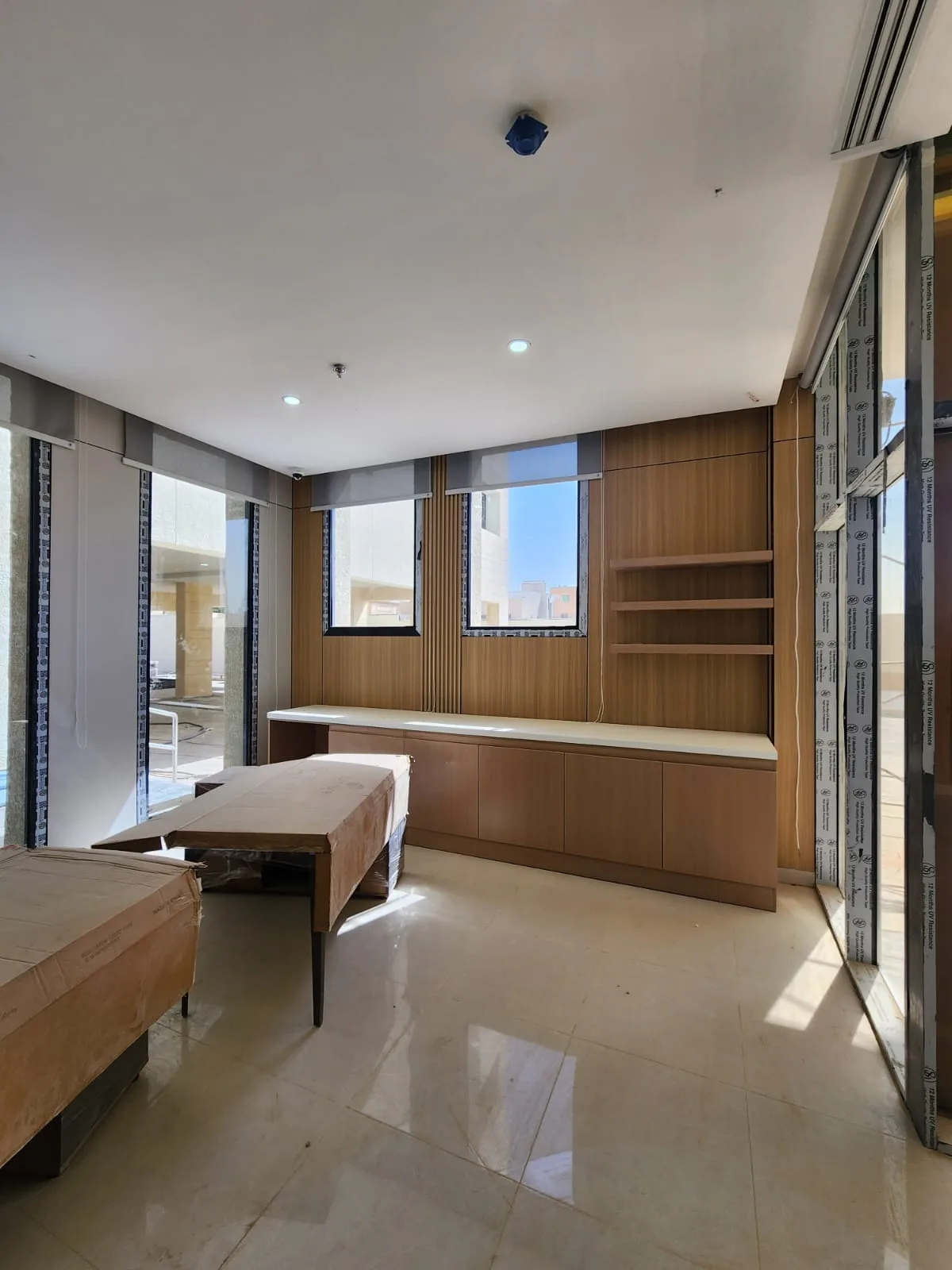 The room after the cladding, built-in desk and shelving were fitted and the floor polished