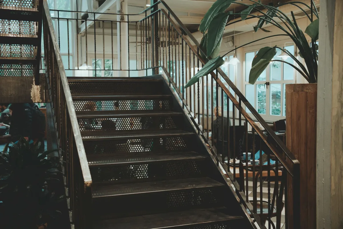 A staircase with metal railings inside a space
